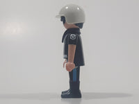 1992 Geobra Playmobil Black Hair Black Uniform White Helmet Police Officer 2 3/4" Tall Toy Figure