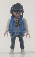 1992 Geobra Playmobil Black Hair Black Pants Light Blue and Grey Z Shirt with Blue Vest Rock Star Style 2 3/4" Tall Toy Figure