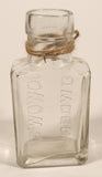 Vintage Kuowow's Powder Heavy Embossed Glass Bottle