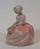 Vintage Chalkware Sitting Girl in Victorian Pink Dress with Bonnet and Flower Basket Figurine - Treasure Valley Antiques & Collectibles