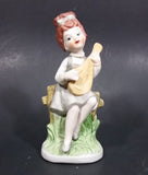 Vintage Victorian Girl Sitting on a Fence Playing a Mandolin Ceramic Figurine - Treasure Valley Antiques & Collectibles