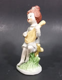 Vintage Victorian Girl Sitting on a Fence Playing a Mandolin Ceramic Figurine - Treasure Valley Antiques & Collectibles