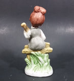 Vintage Victorian Girl Sitting on a Fence Playing a Mandolin Ceramic Figurine - Treasure Valley Antiques & Collectibles