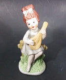 Vintage Victorian Girl Sitting on a Fence Playing a Mandolin Ceramic Figurine - Treasure Valley Antiques & Collectibles