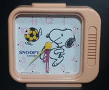 Vintage 1958 Citizen United Feature Syndicate Snoopy Playing Soccer Pink Alarm Clock Collectible - Treasure Valley Antiques & Collectibles