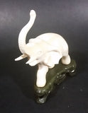 Vintage White Ivory Look Plastic Elephant on Rock Looking Stand with Trunk Up Made in Hong Kong - Treasure Valley Antiques & Collectibles
