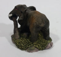 Elephant with Tusks Pulling a Log With It's Trunk Resin Figurine - SABRE - Treasure Valley Antiques & Collectibles