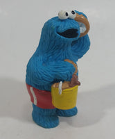 Applause Muppets Sesame Street Cookie Monster Character In Beach Shorts with a Pail of Shells Holding a Conch Shell To His Ear 3" Tall Hard Rubber PVC Toy