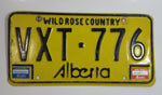 Vintage 1980s Alberta Wild Rose Country Yellow with Black Letters Passenger Vehicle Metal License Plate Tag VXT - 776