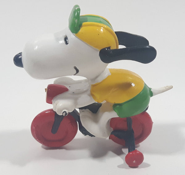 Vintage United Feature Peanuts Snoopy Learning To Ride A Bike On Bicycle With Training Wheels 2 1/2" Tall PVC Toy Figure Made in Hong Kong