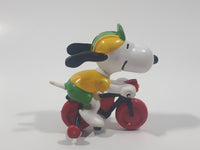 Vintage United Feature Peanuts Snoopy Learning To Ride A Bike On Bicycle With Training Wheels 2 1/2" Tall PVC Toy Figure Made in Hong Kong