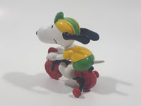 Vintage United Feature Peanuts Snoopy Learning To Ride A Bike On Bicycle With Training Wheels 2 1/2" Tall PVC Toy Figure Made in Hong Kong