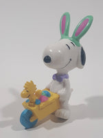 United Feature Peanuts Snoopy Easter Bunny Pushing Wheelbarrow Of Eggs with Woodstock 2 3/4" Tall PVC Toy Figure