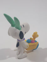 United Feature Peanuts Snoopy Easter Bunny Pushing Wheelbarrow Of Eggs with Woodstock 2 3/4" Tall PVC Toy Figure