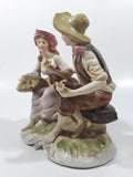 Vintage Man and Woman Sitting Holding Flowers 6 1/4" Tall Porcelain Figurine