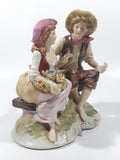Vintage Man and Woman Sitting Holding Flowers 6 1/4" Tall Porcelain Figurine
