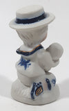 Vintage Brinns Blue and White French Colonial Boy Holding White Puppy Dog 4" Tall Porcelain Figurine