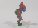 Blue Skinned Elf Wearing Red and Green Clothes Sneakily Carrying Bag While Walking On Tip Toes 2 1/2" Tall Toy Figure