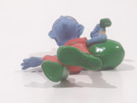 Blue Skinned Elf Wearing Red and Green Clothes Sneakily Carrying Bag While Walking On Tip Toes 2 1/2" Tall Toy Figure