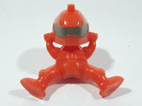 Orange Character with Helmet In Riding Pose With Arms Up 1 7/8" Tall Plastic Toy Figure