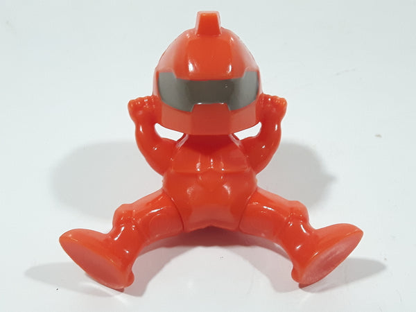 Orange Character with Helmet In Riding Pose With Arms Up 1 7/8" Tall Plastic Toy Figure