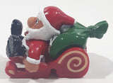 Santa Claus On His Sled with Bag of Presents 2 5/8" Long Toy Figure