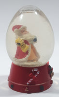 Santa Claus 4 1/4" Tall Red Resin Snow Globe