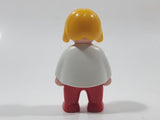 1990 Geobra Playmobil Girl with Blond Hair in White Shirt with Green Striped Sweater and Red Pants 2 1/4" Tall Toy Figure