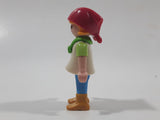 1992 Geobra Playmobil Girl with Blonde Hair Red Bonnet in White and Green Top and Blue Pants 2 1/8" Tall Toy Figure