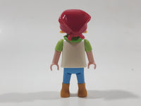 1992 Geobra Playmobil Girl with Blonde Hair Red Bonnet in White and Green Top and Blue Pants 2 1/8" Tall Toy Figure