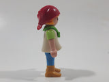 1992 Geobra Playmobil Girl with Blonde Hair Red Bonnet in White and Green Top and Blue Pants 2 1/8" Tall Toy Figure